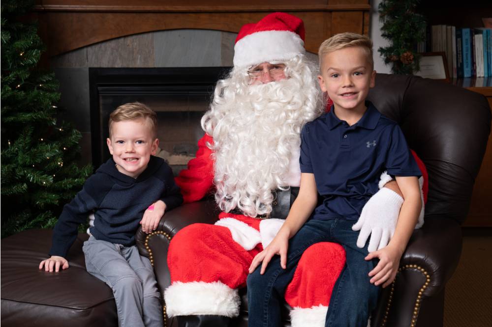 Two kids taking a photo with Santa.
